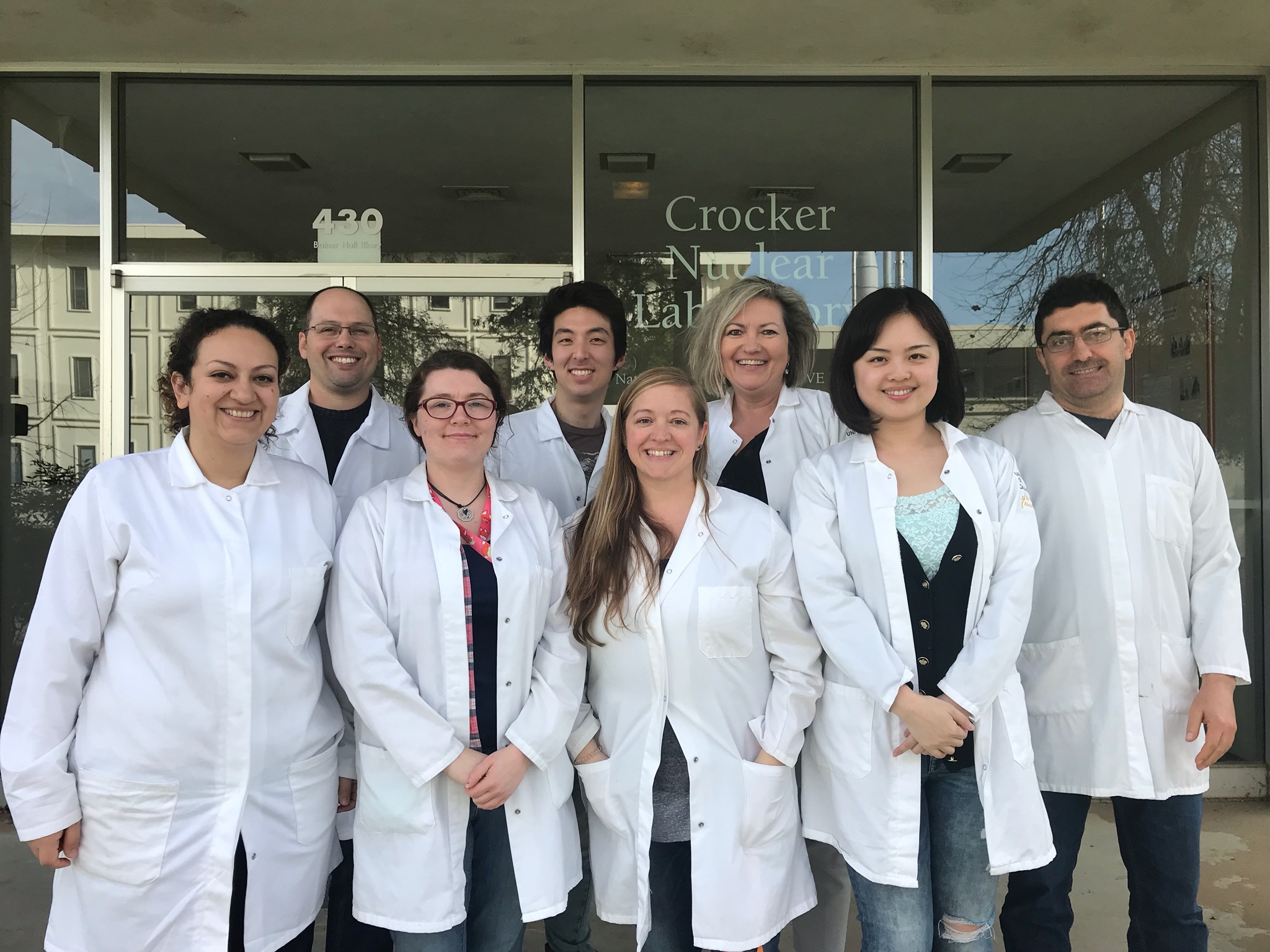 Image: photo of lab staff in front of Crocker Nuclear Lab building.
