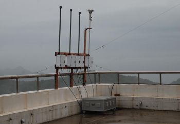 Image: Outdoor IMPROVE aerosol sampler during a gray, rainy day.