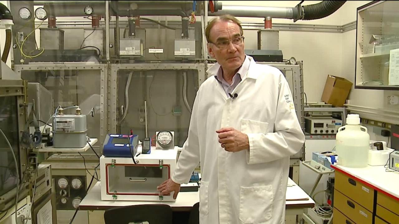 Image: Dr. Pinkerton, in a white lab coat, stands in a laboratory space.